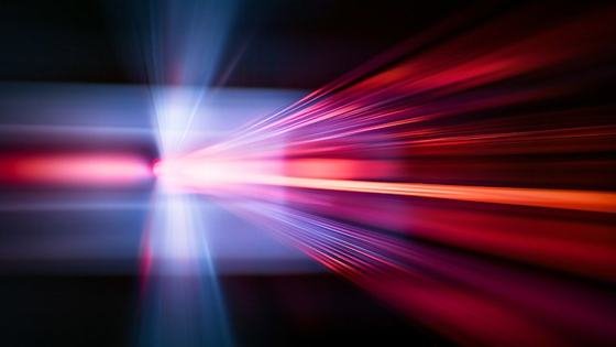 A burst of red and blue light accelerating outward