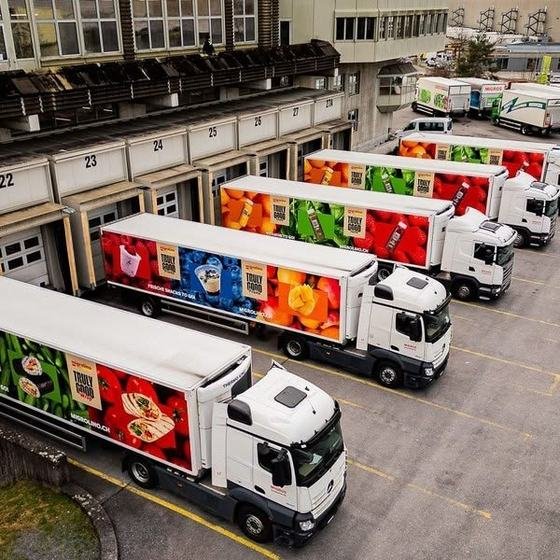 Refrigerated delivery trucks loading at food distribution docks