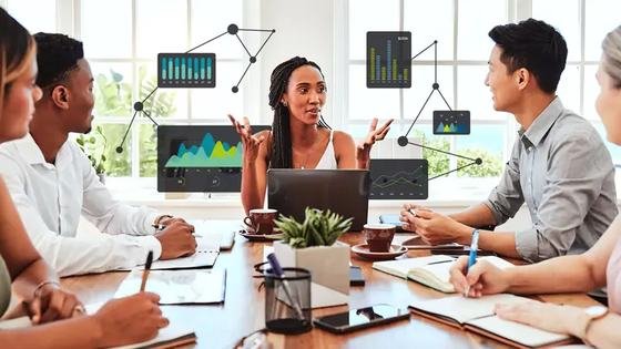 A team around a meeting table with analytics charts overlaid